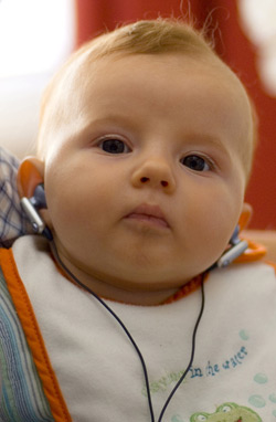 a baby wearing earbuds